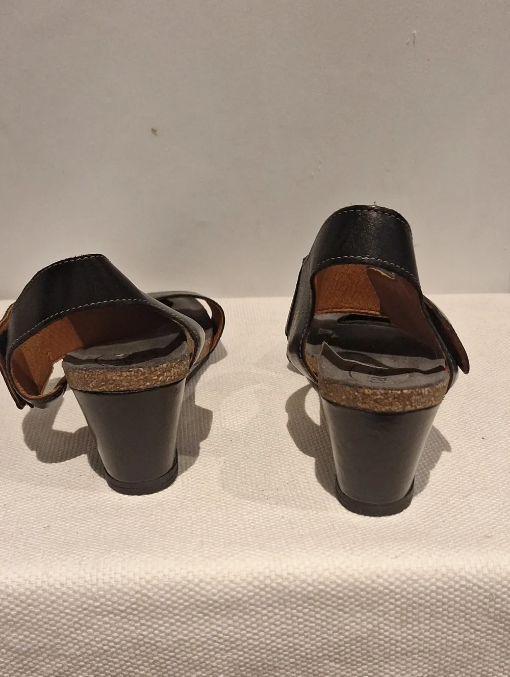 Taos Carousel 2 Black Leather Two-Strap Wedge Sandals With Silver Medalion